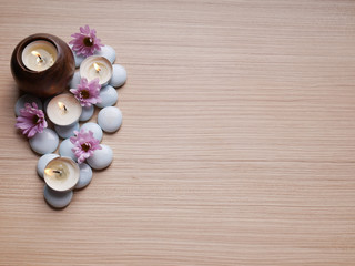 Spa still life concept,Close up of spa theme on wood background with burning candle and bamboo leaf and flower