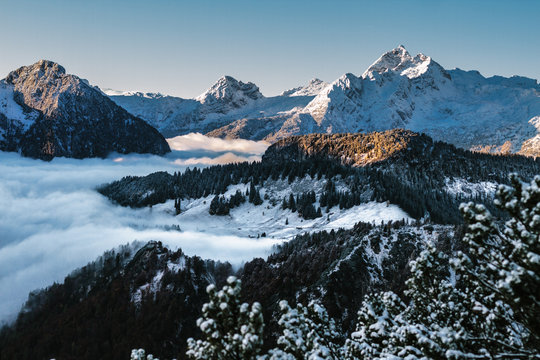 fog into valley surrounded by snowcovered mountain landscape
