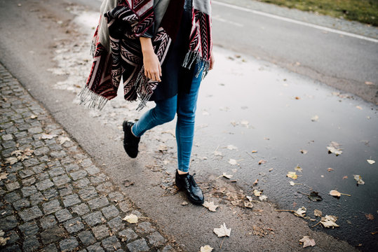 Woman Walking On The Street During Fall