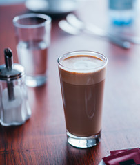 Glass of latte coffee on table