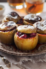Brown plate of baked apples with cranberries