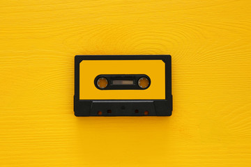 Retro cassette tape over yellow wooden table. top view. copy space