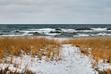 Rough lake and snow covered winter shoreline