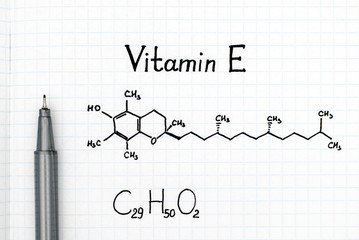 Chemical formula of Vitamin E with black pen