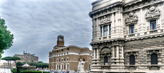 Partial view of the facade of the Supreme Court of Cassation in the square of the Court. In the background the castle called "Sant Angelo" in Rome, Italy. Sky with many dark clouds