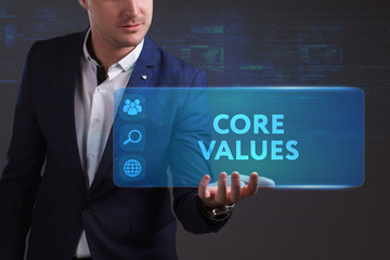 Business, Technology, Internet and network concept. Young businessman working on a virtual screen of the future and sees the inscription: Core values