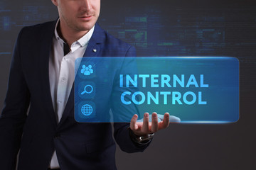 Business, Technology, Internet and network concept. Young businessman working on a virtual screen of the future and sees the inscription: Internal control