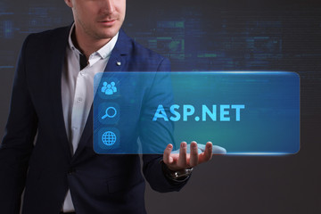 Business, Technology, Internet and network concept. Young businessman working on a virtual screen of the future and sees the inscription: ASP.NET