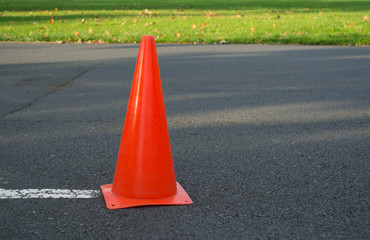 Orange traffic safety cone on the road.