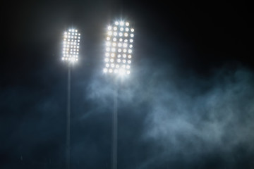 Fototapeta premium stadium lights and smoke against dark night sky background