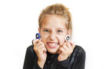 The young girl expresses the emotions of anger by holding spinners in her hands