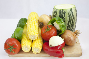 A bunch of vegetables and fruits including tomato Zucchini, Courgette, on the white background