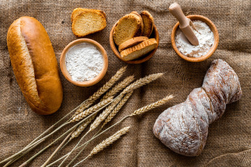 bakery set with fresh wheaten bread on table rystic background top view