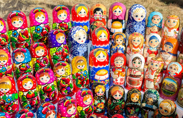 Fototapeta na wymiar Large selection of matryoshkas Russian souvenirs at the gift shop
