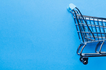 Shopping cart on a blue background © ink drop