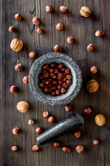 close up of ingredients for making spices and herbs in mortar wooden background top view