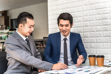 Asian Businessman Present Business Report to Partner in Office