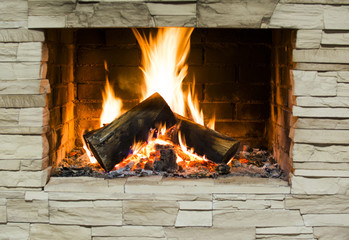 Burning wood in stone fireplace