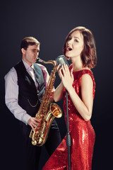 Obraz na płótnie Canvas Female singer and saxophonist