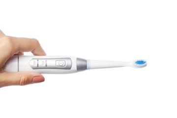 Obraz premium Woman hand holding a toothbrush isolated on white