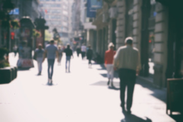     People walking in the street, blurry 
