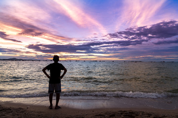 Fototapeta premium Silhouette Adult Men are Exercise and Relax on the Beach in Sunset Time