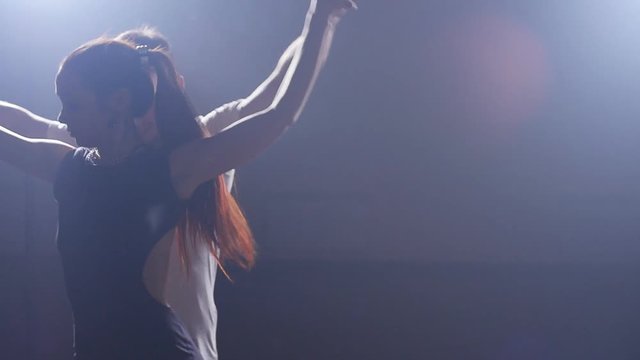Beauty couple dancing bachata in dark room