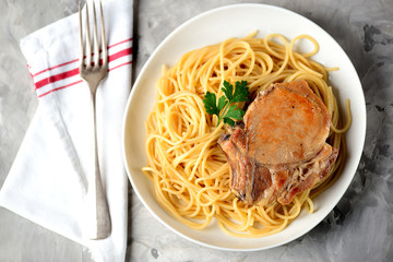 Grilled pork chop with pasta.