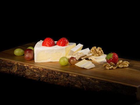 Brie cheese on a chopping board.