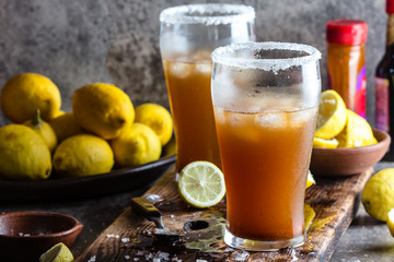 Mexican Michelada. Traditional Latin American mexican spicy refreshing beer drink with lemon juice, salt, ice tabasco and english worcestershire sauce