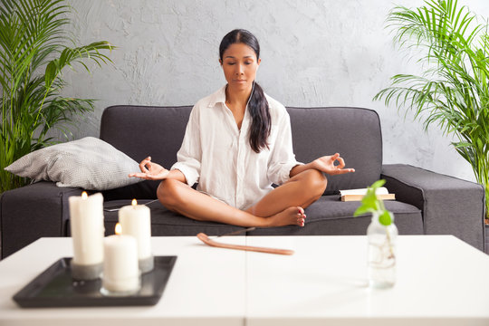 Woman Meditating At Home