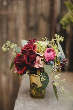 Pink and Red Wedding Bouquet in a Gold Vase