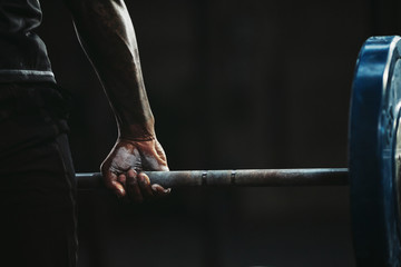 Close-up of a man's hand lifting barbell