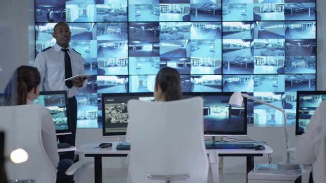  Security officer communicating with staff in observation control room