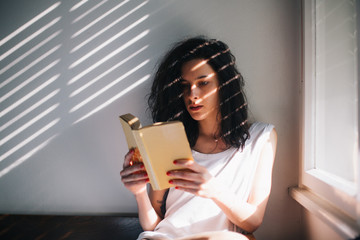 Brunette woman reading a book