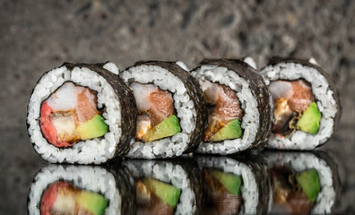 Sushi roll with salmon, shrimps and avocado