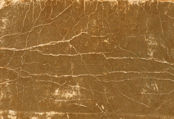 Old scratched and torn paper book cover surface.