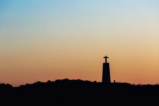 silhouette  at sunset of Cristo Rei monument in Lisbon, Portugal