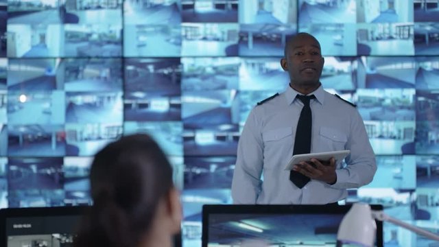  Security officer communicating with staff in observation control room