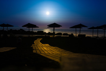 Wooden pavement on the beach at sunset time