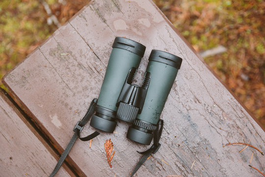 New binoculars laying on a picnic table