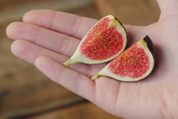 Delicious fresh purple figs in hand view   