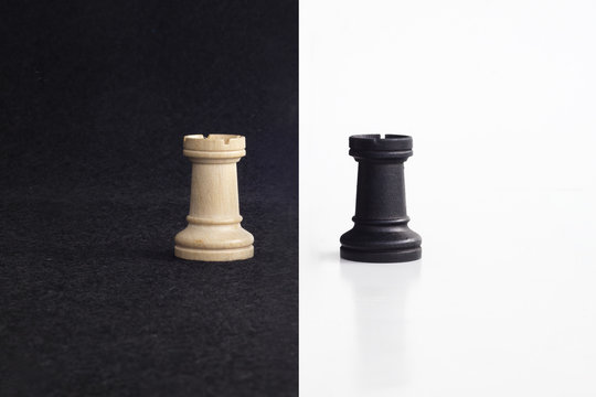 Pair of tower chess peaces confronted as opposites in black and white background