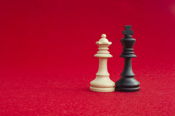 White queen and black king, traditionally confronted in chess game, have reconciled. Image in...