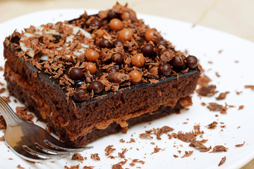 Chocolate cake on a white plate. Shallow depth of field.