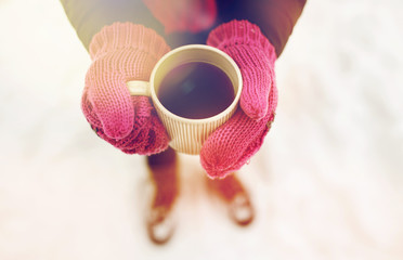 close up of woman with tea mug outdoors in winter