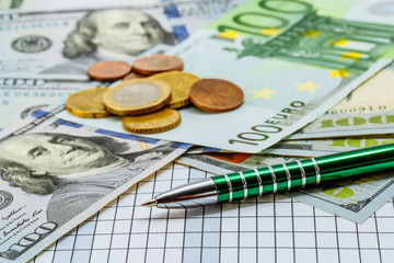 American dollars and euro banknotes. Coins. Money. Currency. Cash. Background with money. Ballpoint pen next to the banknotes.