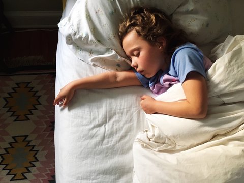 little girl asleep with the sun on her face
