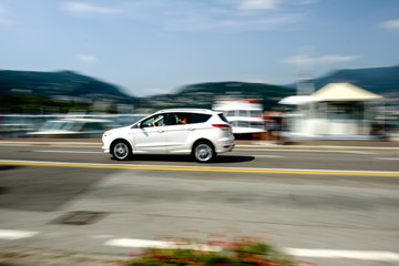 Fototapeta na wymiar Car in motion with blurred background