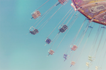 Empty swing ride chairs in motion